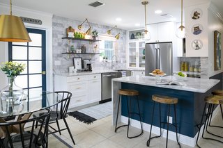 The re-organized layout provides an open, continuous flow between cooking, prep, and dining spaces.