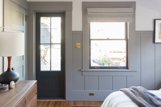 The new exterior door and adjacent window draw plentiful daylight into the bedroom space.