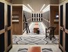 A boot room and changing area for skiers features light wood lockers, dark accents, and decorative Navajo influenced rugs that draw the mountain style into even the locker rooms. Photo 17 of Caldera House modern home
