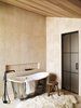 Modern home with Bath Room, Porcelain Tile Wall, Soaking Tub, and Freestanding Tub. This private bath is a dream retreat after a long day exploring. A tin soaker tub, lush fur rug, and large tiles in natural tones create an ideal, calming escape. Photo 5 of Caldera House