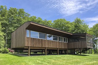 Built on stilts, the dwelling appears to float gently atop the landscape.