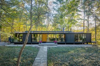 Rescued from demolition, a cantilevered home in Michigan becomes a refined retreat with a magnificent indoor/outdoor connection.