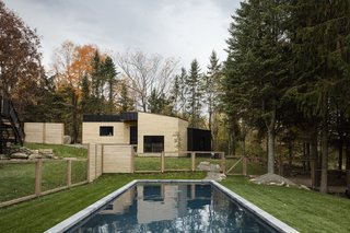 The backyard features an in-ground pool and a garage/workshop. 