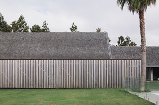 The simple, gabled forms extend past one another, creating open spaces for outdoor enjoyment. Timber-clad walls and shingle roofs tie all the volumes together. 