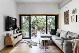 By increasing the width of the sliding glass doors, Broza immensely improved the apartment's visual and physical connection to the outdoors.