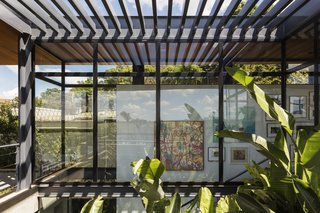 An interior courtyard is covered by trellised shading above, filtering light into the living spaces. 