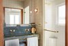 Modern home with Bath Room, Enclosed Shower, Ceramic Tile Wall, Wall Lighting, Stone Counter, Full Shower, Marble Counter, and Drop In Sink. A monolithic, imported stone vanity in the bathroom is accented by brass fixtures and hand-cut and crafted tile. Photo 8 of Hotel Joaquin