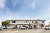 Modern home with Exterior, Shingles Roof Material, Wood Siding Material, House Building Type, and Hipped RoofLine. This roadside motel is no longer a forgotten lodge. Photo 3 of Hotel Joaquin
