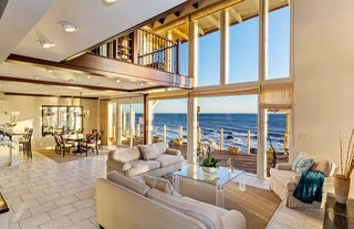 The grand, two-story living space is filled with natural light.