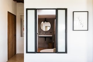 The bathroom includes operable windows, which provide a fireplace and outdoor view while bathing.