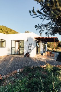 The walls and parts of the roof are original to the structure. The steel-framed windows and openings are new.