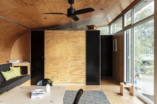 Large windows face west, providing uninterrupted views of the valley below and mountains beyond. Sliding exterior shutters and low-E glazing protect the interior from afternoon sun.