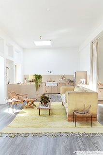 The maple kitchen cabinets are punctuated by leather and brass pulls.