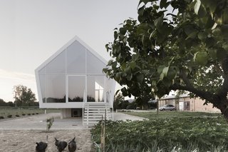 Although innovative in construction, the simple and pure gabled form relates to the character of the rural setting and the agrarian use of the building. Elevated slightly above the ground, the home inflicts minimal intrusion on the existing landscape.