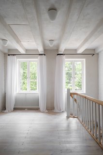 The first floor is calm and serene with the same muted color palette that fills the ground floor.