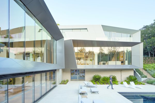 The exterior form optimizes views, framing vistas of the surroundings. The metal frames twist and taper, providing passive solar control for interior spaces and outdoor patios.