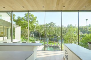 The kitchen is the focal point of the home, with views to the rest of the house and the surrounding grounds.