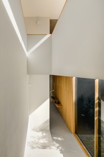 Views of trees, foliage, and greenery can be found from any space within this home, linking the occupants to nature. 