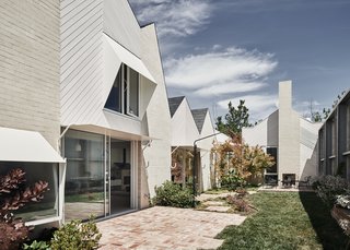 The exterior materials are simple and refined. Brickwork and timber-framed openings meet minimal, structural steel awnings, significantly reducing construction cost while also creating a unique pattern and material beauty to display.