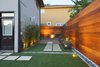 Modern home with Outdoor, Back Yard, Hardscapes, Grass, Small Patio, Porch, Deck, Wood Patio, Porch, Deck, Horizontal Fences, Wall, Wood Fences, Wall, and Landscape Lighting. Symmetry Photo 2 of White House