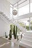 Modern home with Hallway and Concrete Floor. The Poul Henningsen pendant lights the stairwell. A cactus garden runs the length of the front yard and extends into the house. Photo 5 of Santa Monica Residence
