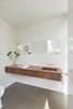 Modern home with Bath Room, Wood Counter, Concrete Floor, Wall Mount Sink, Pendant Lighting, Ceramic Tile Wall, and One Piece Toilet. The Moon pendant in the powder room is one of Verner Panton's earliest luminaires. It consists of ten ring-shaped blades positioned in such a way that they can move. The Moon pendant justifiably gets its name from its shape and the quality of light coming from it. The fan-shaped discs hide the bulb and at the same time serve as reflectors, through which a soft light is spread throughout the room. It is a spherical lamp of white metal with vertical lamellae, arranged like a fan, for individual regulation of the light. Photo 4 of Santa Monica Residence