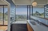 Modern home with Bath Room, Engineered Quartz Counter, Porcelain Tile Floor, Undermount Tub, Ceiling Lighting, Undermount Sink, Wall Lighting, and Porcelain Tile Wall. Detail of bathroom Photo 9 of Skyline House