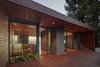Modern home with Outdoor, Front Yard, Shrubs, Small Patio, Porch, Deck, and Wood Patio, Porch, Deck. Entry at dusk Photo 10 of Skyline House