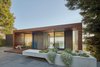 Modern home with Outdoor, Front Yard, Shrubs, Trees, Hardscapes, Grass, Small Patio, Porch, Deck, Gardens, Raised Planters, Landscape Lighting, and Metal Fences, Wall. Front outdoor area Photo of Skyline House