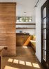 Modern home with Wood Counter, Medium Hardwood Floor, Wood Backsplashe, Recessed Lighting, Wood Cabinet, Refrigerator, Range, Range Hood, Microwave, Dishwasher, Undermount Sink, Awning Window Type, Metal, Table, and Kitchen. Shadows from Dining Room window: A view of the Kitchen with clerestory windows above shelves beyond Photo 5 of Boise Residence