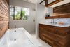 Modern home with Undermount Sink, Marble Counter, Recessed Lighting, Windows, Casement Window Type, and Metal. Bathroom with reclaimed wood wall and vanity. Clerestory above vanity and shower with steel windows allow for more natural light Photo 11 of Boise Residence