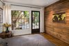 Modern home with Medium Hardwood Floor, Recessed Lighting, Bed, Swing Door Type, Exterior, Wood, Windows, Picture Window Type, Casement Window Type, and Metal. Bedroom with steel windows to view and access rear yard deck. Art by Chris McCullough Photo 12 of Boise Residence