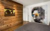 Modern home with Bedroom, Bed, Recessed Lighting, and Medium Hardwood Floor. Bedroom walls wood reclaimed wood and art by Chris McCullough Photo 16 of Boise Residence