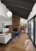 Modern home with Recessed Lighting, Pendant Lighting, Medium Hardwood Floor, Doors, Exterior, Metal, and Sliding Door Type. Living room with fireplace, multiple ceiling levels and exterior deck access. Dining Room beyond Photo 11 of Allaseba Residence