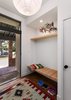 Modern home with Medium Hardwood Floor, Wood, Exterior, Swing Door Type, Awning Window Type, and Metal. Entry with built-in bench and shelf Photo 14 of Allaseba Residence