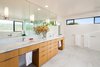 Modern home with Marble Counter, Undermount Sink, Corner Shower, Undermount Tub, Open Shower, Wall Lighting, Stone Slab Wall, Marble Wall, Two Piece Toilet, Windows, Metal, and Casement Window Type. Bathroom vanity Photo 3 of Bowling Green Residence