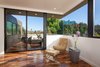Modern home with Recessed Lighting, Chair, Medium Hardwood Floor, Metal, Exterior, Windows, Sliding Door Type, Picture Window Type, and Casement Window Type. Bedroom corner seating with private balcony beyond Photo 2 of Bowling Green Residence