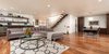 Modern home with Sectional, Coffee Tables, Sofa, Chair, Recessed Lighting, Pendant Lighting, Medium Hardwood Floor, Corner Fireplace, Staircase, Wood Tread, and Glass Railing. Living Room with feature Dining Room, staircase, and Breakfast Nook beyond Photo 6 of Bowling Green Residence