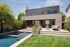 Modern home with Trees, Hardscapes, Shrubs, Back Yard, Grass, Raised Planters, Large Pools, Tubs, Shower, Swimming Pools, Tubs, Shower, Lap Pools, Tubs, Shower, Small Patio, Porch, Deck, Concrete Pools, Tubs, Shower, Concrete Patio, Porch, Deck, Exterior, Sliding Door Type, Metal, Windows, and Sliding Window Type. Rear yard with swimming pool, spa and covered patio Photo 5 of Bowling Green Residence