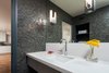 Modern home with Bath Room, Engineered Quartz Counter, Medium Hardwood Floor, Undermount Sink, Open Shower, Full Shower, Wall Lighting, Recessed Lighting, Stone Tile Wall, and Two Piece Toilet. Bathroom Photo 10 of Bowling Green Residence