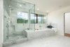 Modern home with Marble Counter, Stone Counter, Undermount Tub, Recessed Lighting, Open Shower, Marble Wall, Corner Shower, Undermount Sink, Two Piece Toilet, Stone Slab Wall, Windows, Casement Window Type, and Metal. Bathroom shower and tub Photo 4 of Bowling Green Residence