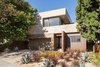 Modern home with Front Yard, Hardscapes, Walkways, Trees, Grass, Concrete Patio, Porch, Deck, Pavers Patio, Porch, Deck, Decomposed Granite Patio, Porch, Deck, Stone Patio, Porch, Deck, Vertical Fences, Wall, Wood Fences, Wall, Exterior, Metal, Windows, Swing Door Type, and Sliding Window Type. Front yard Photo of Bowling Green Residence
