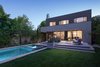 Modern home with Outdoor, Back Yard, Shrubs, Hardscapes, Grass, Trees, Raised Planters, Large Pools, Tubs, Shower, Swimming Pools, Tubs, Shower, Lap Pools, Tubs, Shower, Concrete Pools, Tubs, Shower, Small Patio, Porch, Deck, and Concrete Patio, Porch, Deck. Rearyard with pool and spa at dusk Photo 13 of Bowling Green Residence