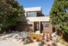 Modern home with Trees, Shrubs, Hardscapes, Grass, Front Yard, Decomposed Granite Patio, Porch, Deck, Walkways, Gardens, Concrete Patio, Porch, Deck, Doors, Vertical Fences, Wall, Swing Door Type, Exterior, and Metal. Front yard Photo 11 of Bowling Green Residence