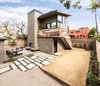 Modern home with Side Yard, Desert, Trees, Back Yard, Hardscapes, Gardens, Walkways, Small Patio, Porch, Deck, Wood Patio, Porch, Deck, Concrete Patio, Porch, Deck, Decking Patio, Porch, Deck, Pavers Patio, Porch, Deck, Decomposed Granite Patio, Porch, Deck, Horizontal Fences, Wall, Wood Fences, Wall, Hanging Lighting, Exterior, Metal, Sliding Door Type, and Picture Window Type. Located in the corner of the lot, the 2-story art studio is connected to the existing main house via a raised deck with outdoor fireplace and a meandering hardscape path Photo of Mar Vista Art Studio