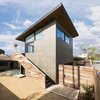 Modern home with Back Yard, Desert, Side Yard, Trees, Walkways, Hardscapes, Small Patio, Porch, Deck, Decomposed Granite Patio, Porch, Deck, Concrete Patio, Porch, Deck, Decking Patio, Porch, Deck, Pavers Patio, Porch, Deck, Horizontal Fences, Wall, Wood Fences, Wall, Hanging Lighting, Sliding Window Type, Metal, Picture Window Type, Wood Tread, Wood Railing, and Doors. The art studio sits above a two-car garage connected to the alley Photo 3 of Mar Vista Art Studio