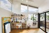 Modern home with Den Room Type, Chair, Track Lighting, Cork Floor, Craft Room Room Type, Storage, Bookcase, Shelves, Desk, Picture Window Type, Sliding Window Type, Doors, Metal, Exterior, and Sliding Door Type. The near 2-story interior space is light filled yet private with roof overhangs clad in wood Photo 4 of Mar Vista Art Studio