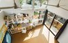 Modern home with Craft Room Room Type, Bookcase, Storage, Desk, Shelves, Chair, Cork Floor, Track Lighting, Sliding Window Type, Doors, Metal, Picture Window Type, Exterior, and Sliding Door Type. View from the book loft mezzanine. Floors are cork tile Photo 5 of Mar Vista Art Studio