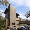 Modern home with Sofa, Coffee Tables, Light Hardwood Floor, Chair, Standard Layout Fireplace, Gas Burning Fireplace, Back Yard, Side Yard, Desert, Hardscapes, Trees, Walkways, Concrete Patio, Porch, Deck, Small Patio, Porch, Deck, Decking Patio, Porch, Deck, Wood Patio, Porch, Deck, Decomposed Granite Patio, Porch, Deck, Pavers Patio, Porch, Deck, Horizontal Fences, Wall, and Hanging Lighting. View of the raised deck, outdoor living room and fireplace at the art studio Photo 9 of Mar Vista Art Studio