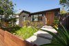 Modern home with Front Yard, Grass, Hardscapes, Trees, Walkways, Gardens, Flowers, Raised Planters, Concrete Patio, Porch, Deck, Wood Fences, Wall, Pavers Patio, Porch, Deck, Horizontal Fences, Wall, Wood, Exterior, Swing Door Type, Sliding Window Type, Metal, Outdoor, Garden, and Metal Fences, Wall. Front yard entry with gate Photo 8 of Ashland Residence
